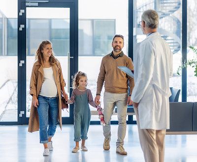 Family walking into lobby with care doctor meeting